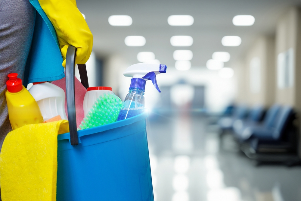 Cleaning,Woman,With,Bucket,And,Cleaning,Supplies,On,Blurred,Background